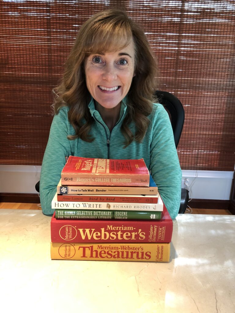 Seana with a stack of books giving ideas on how to declutter.