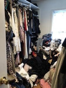 how to tame your unruly closet. picture of a closet overflowing with clothes