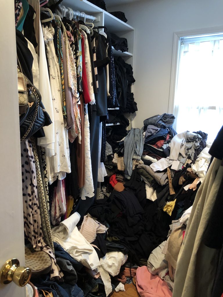 how to take your unruly closet. picture of a closet full of clothing