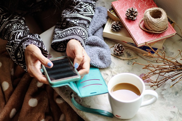 Woman typing on a phone next to a cup of coffee. The Hidden Impact of Social Media on The Home