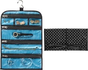 A fabric jewelry roll that hangs on the wall. When it is open, it shows 4 zippered compartments to hold jewelry.